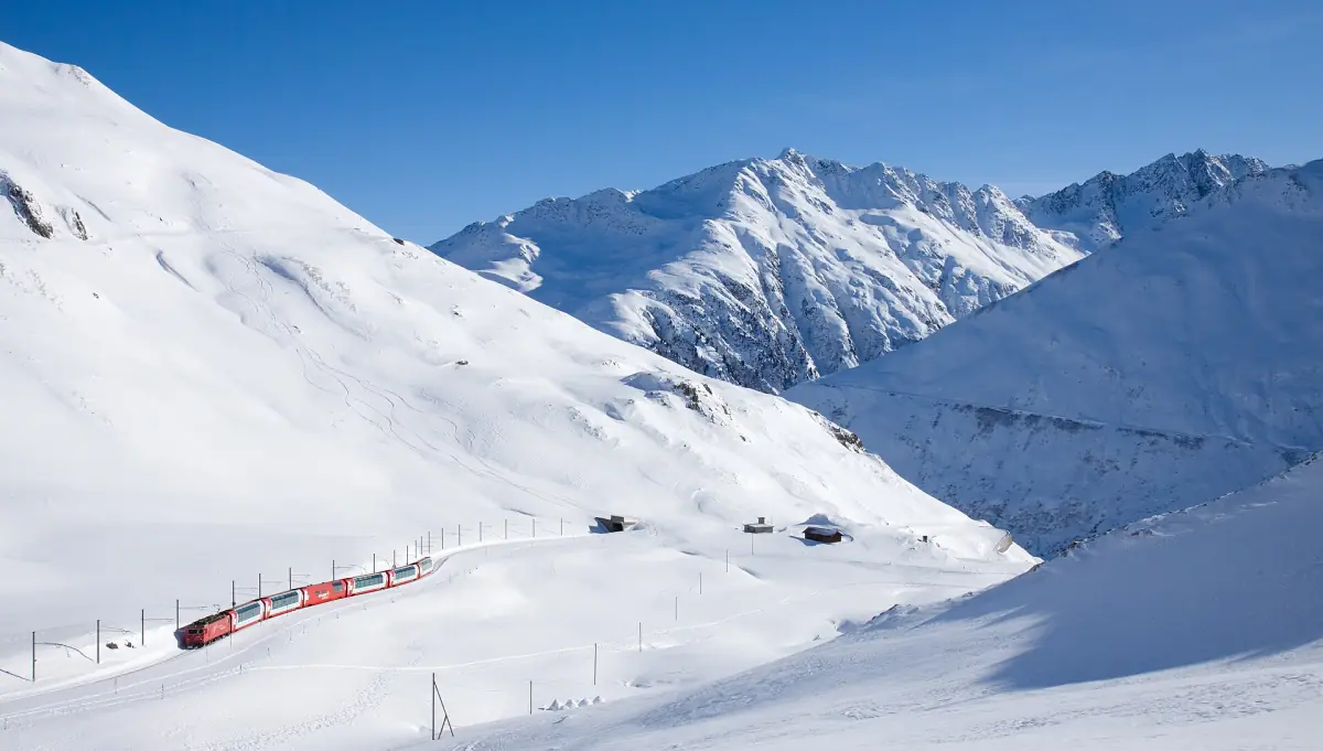 The Glacier Express in the snow below the Oberalp Pass