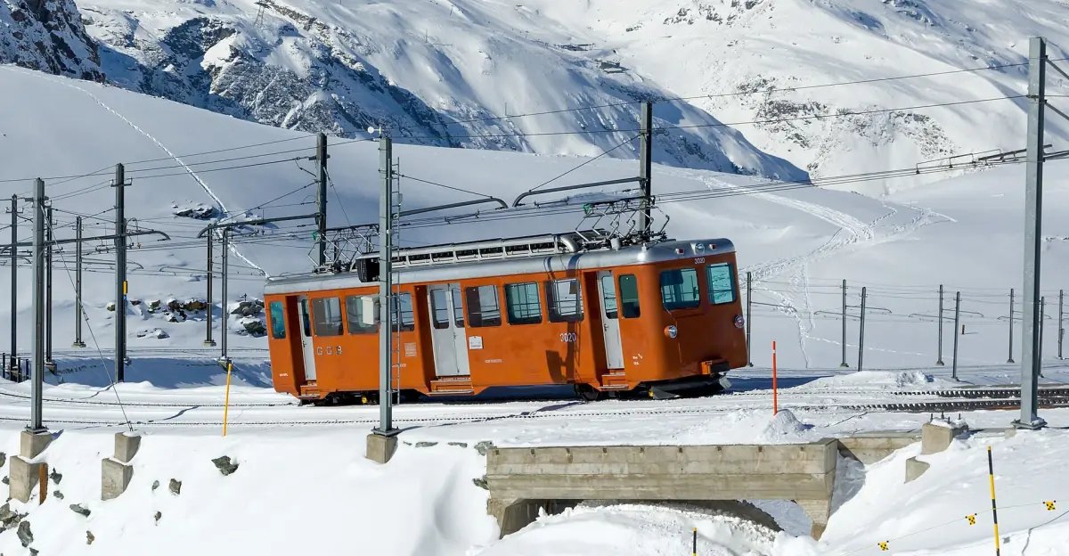 A Gornergrat Railway train in deep snow below the Matterhorn